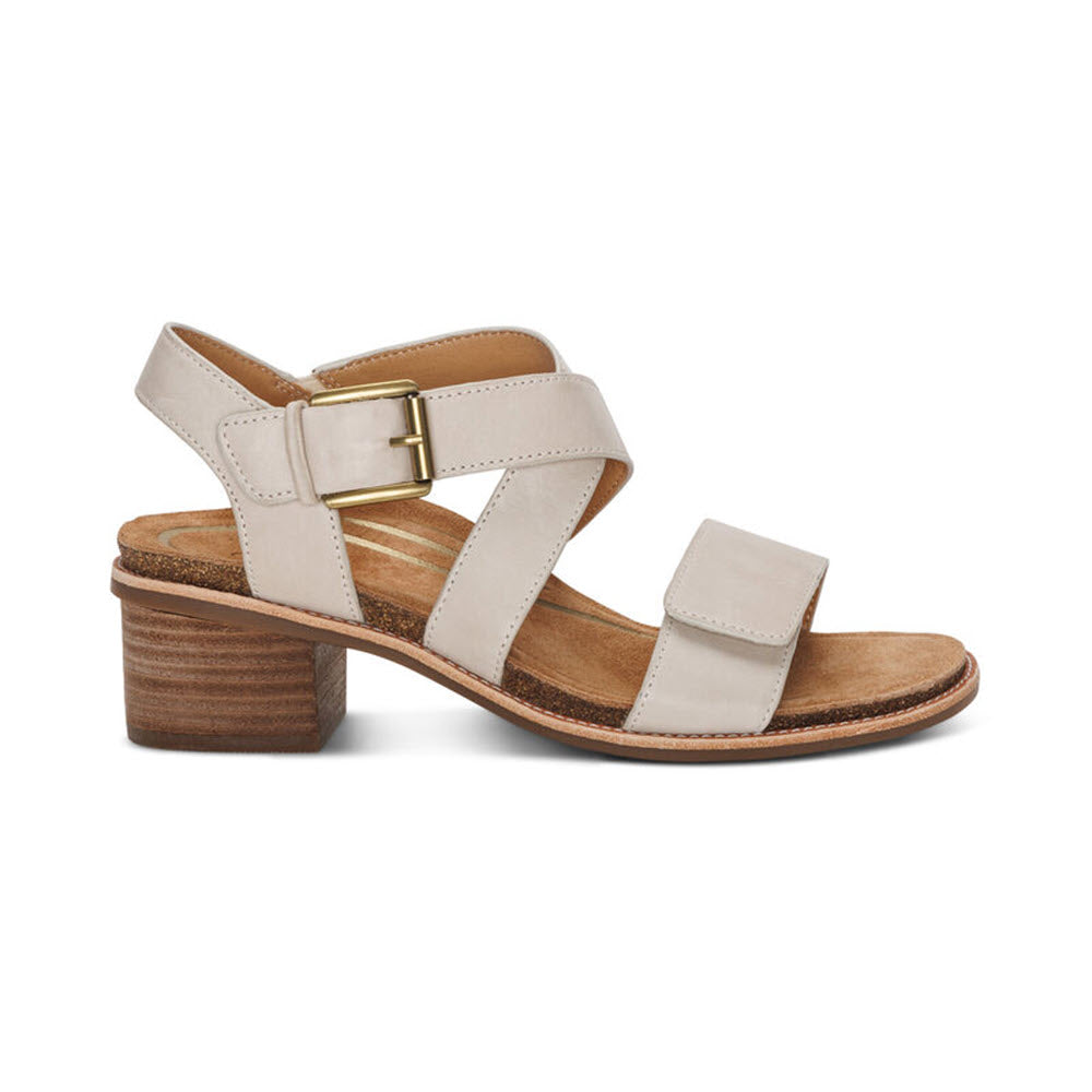 Aetrex Kristin Ivory women&#39;s sandal with a chunky wooden heel, two straps across the foot, and an adjustable hook and loop closure around the ankle, isolated on a white background.
