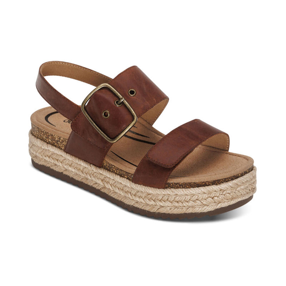 Brown genuine leather sandal with a buckle, featuring the AETREX VANIA WALNUT - WOMENS cork and jute platform sole with arch support, isolated on a white background.