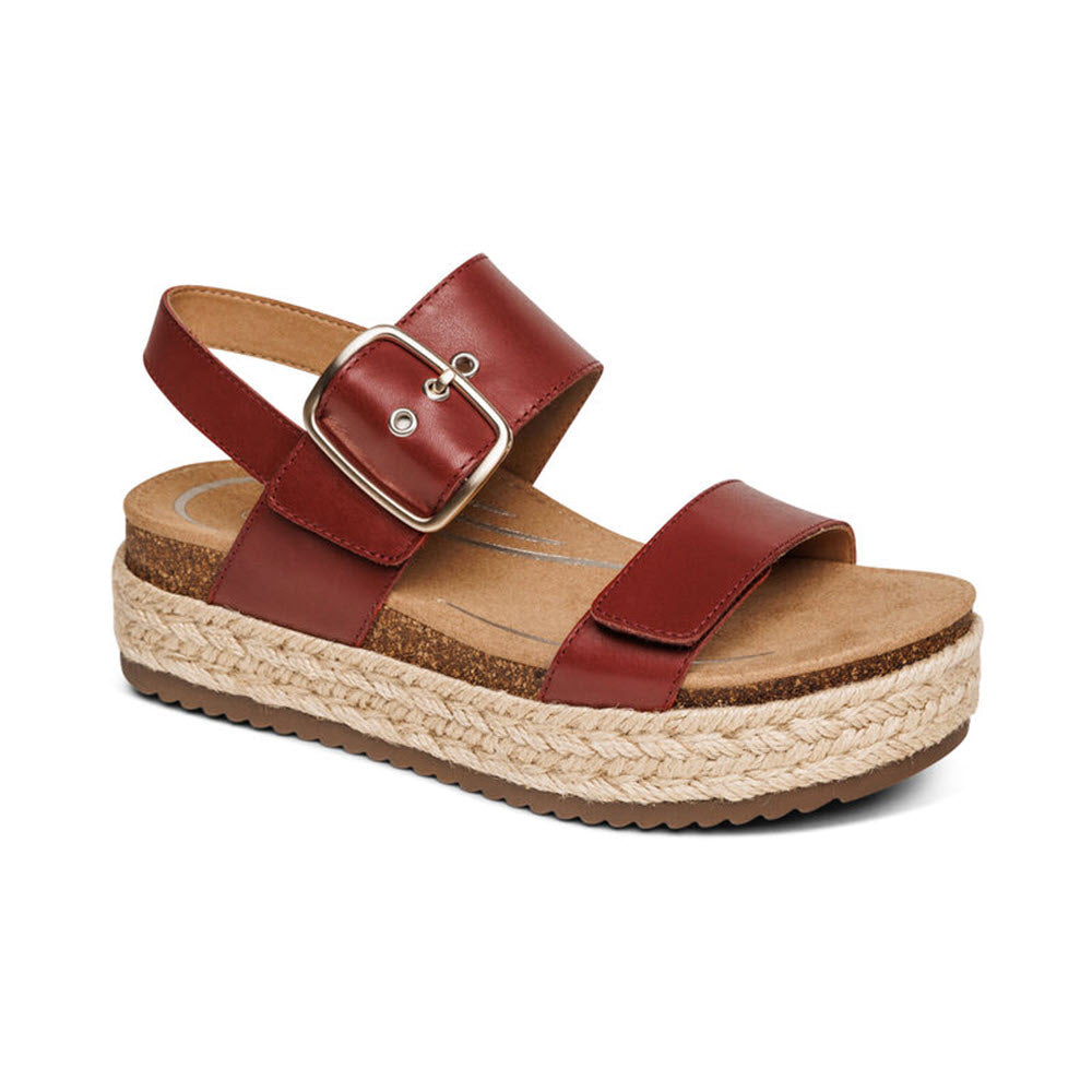 A red Aetrex Vania sandal with a buckle, featuring a cork footbed and a braided jute platform sole.