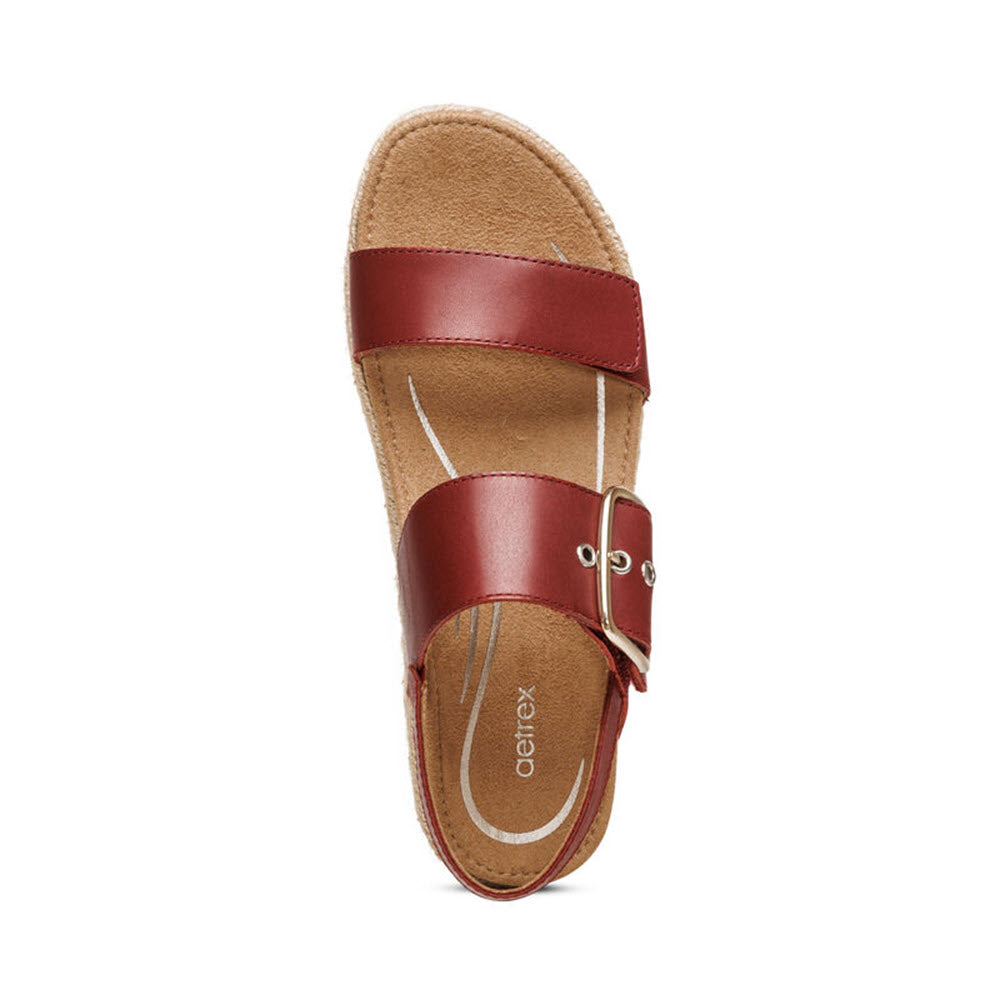 A single red Aetrex Vania leather sandal with adjustable straps and a memory foam cushioned insole, isolated on a white background.