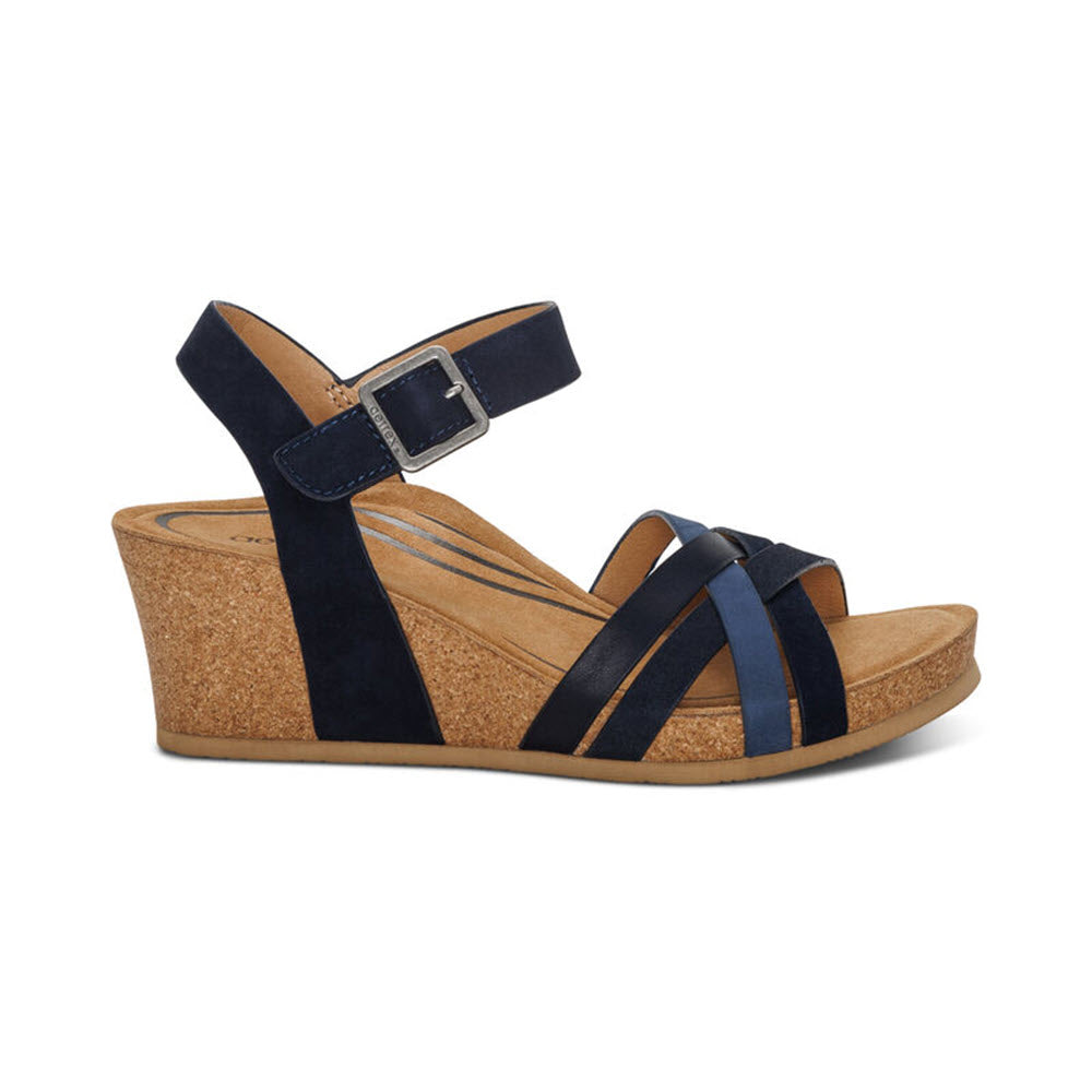A AETREX NOELLE NAVY - WOMENS wedge sandal with a cork heel and an adjustable hook &amp; loop closure, isolated on a white background.