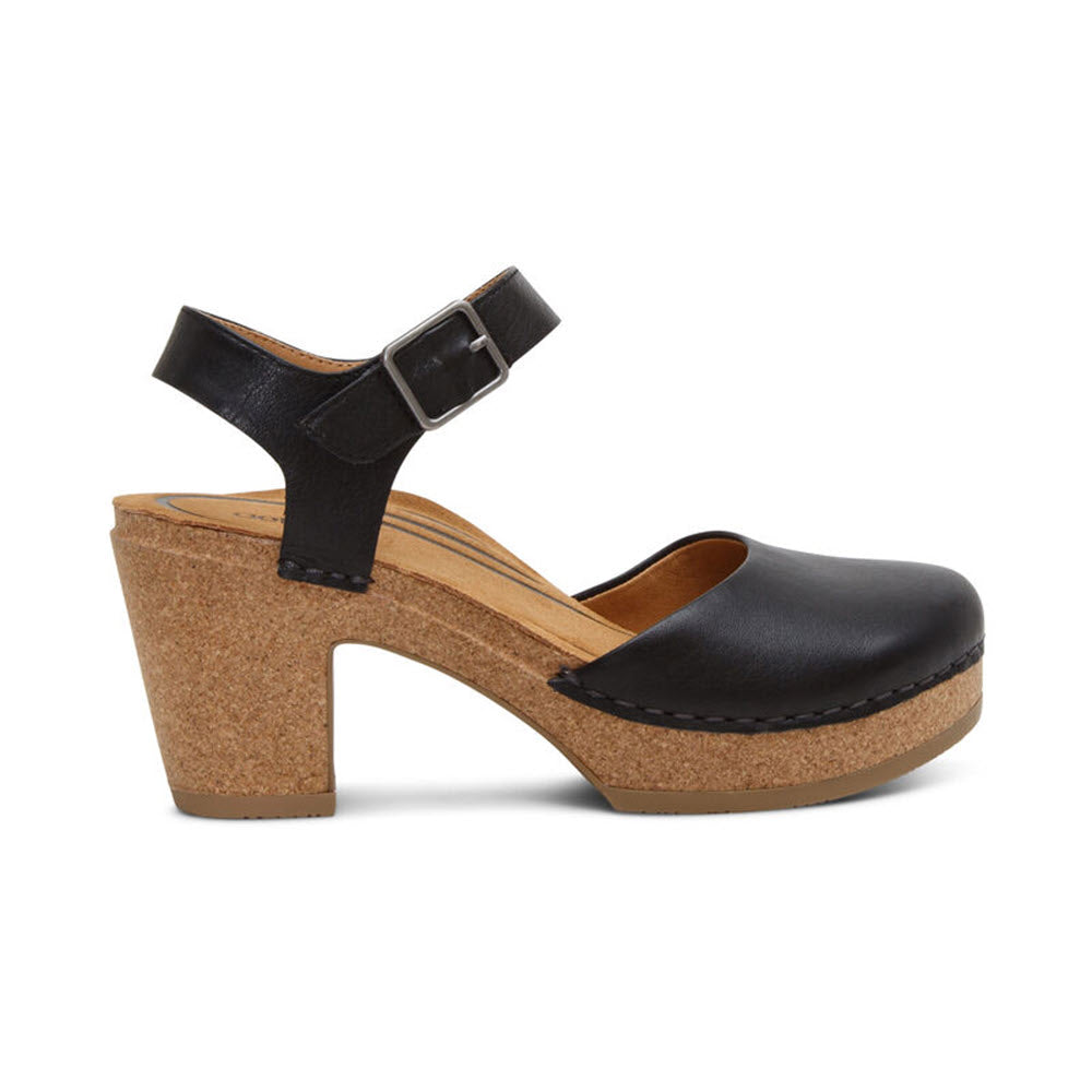 Aetrex Finley Black leather clog with a buckled ankle strap, featuring memory foam cushioning, set on a chunky cork platform heel with stitching details.