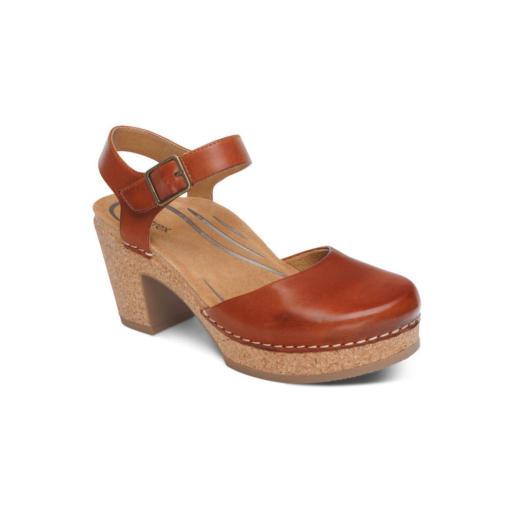 A single Aetrex Finley Cognac women&#39;s leather clog with a buckle strap, cork platform heel, and white stitching on a white background, featuring memory foam cushioning.
