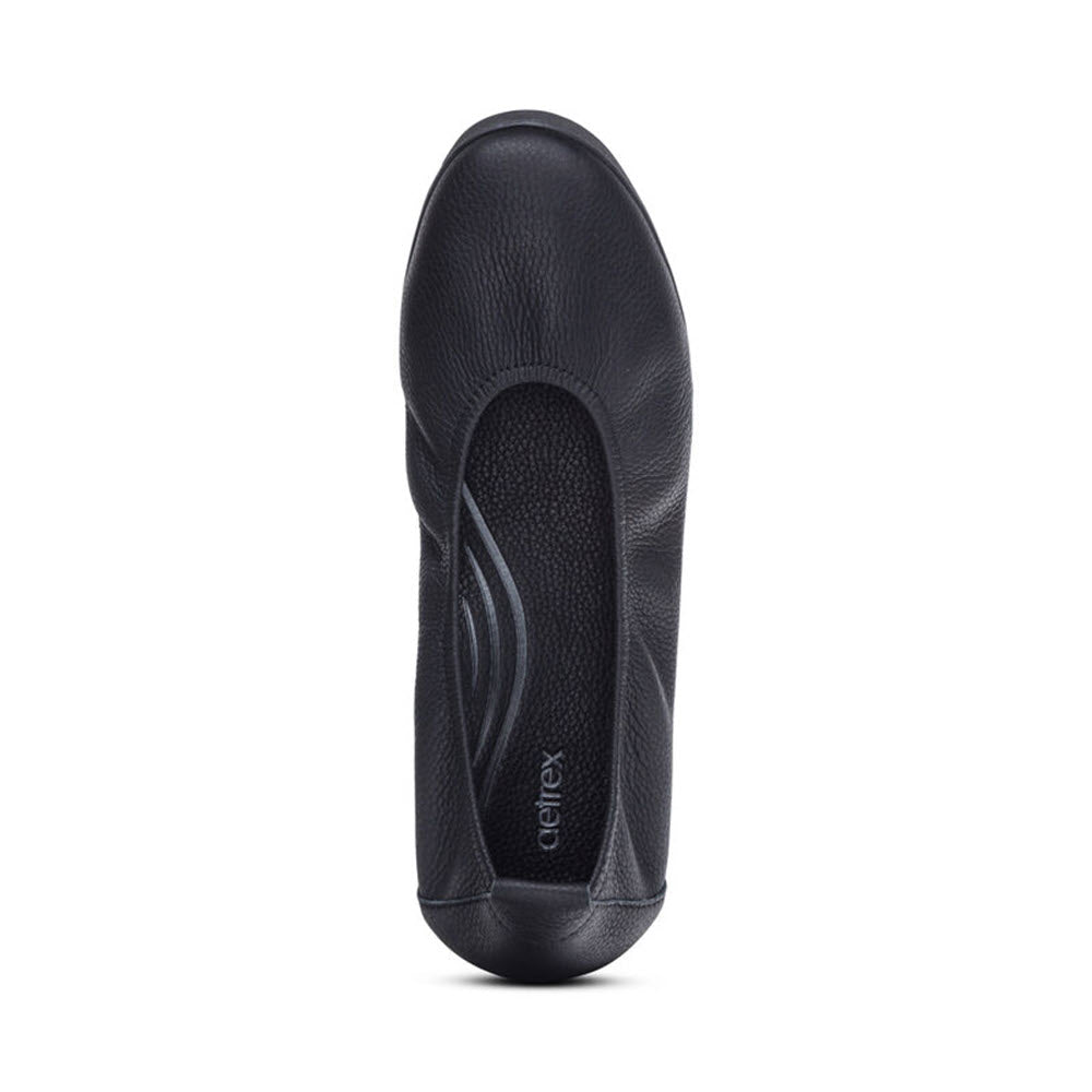 Black leather insole with a contoured design and a gray oval memory foam pad in the heel area, featuring the brand logo &quot;Aetrex&quot; in the center.
