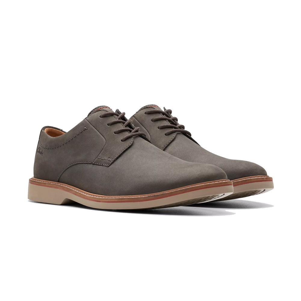 A pair of Clarks Atticus Lt Lace Oxford gray nubuck men&#39;s derby shoes with brown soles, displayed on a white background.