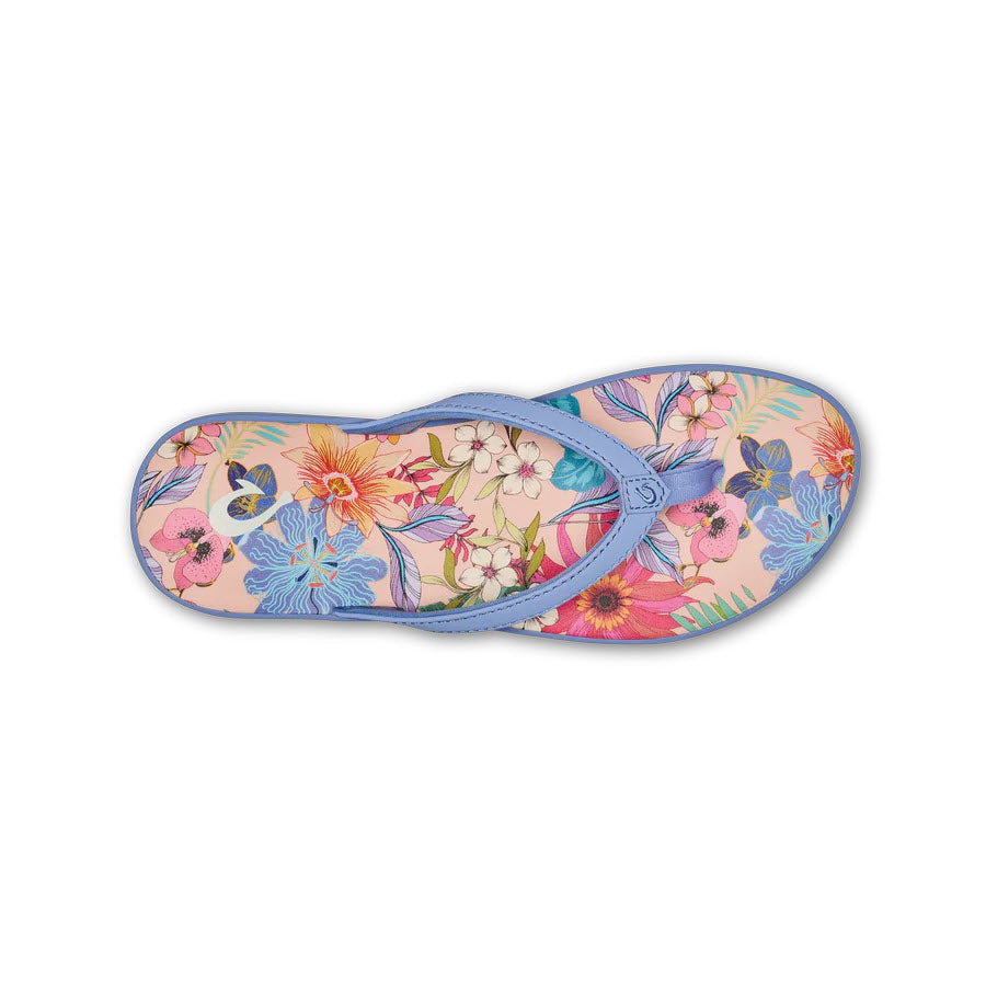 A single OluKai Puawe sandal with a floral pattern and a blue strap, viewed from above.