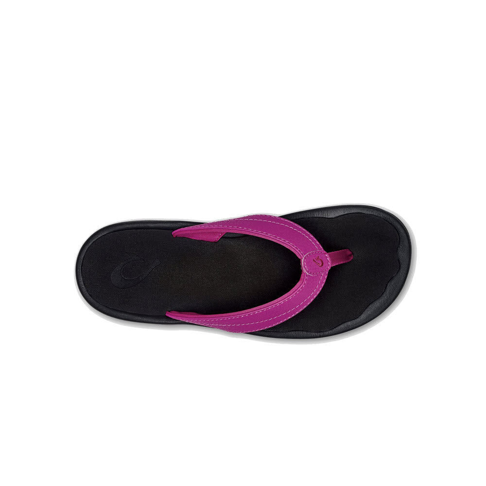 A single Olukai Ohana Orchid Flower womens sandal with a black sole isolated on a white background.
