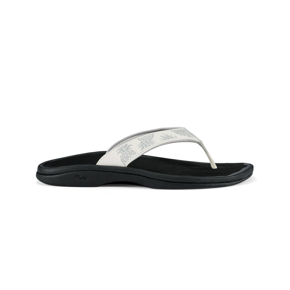 A single Olukai Ohana Bright White water-resistant flip-flop with a patterned strap on a white background.