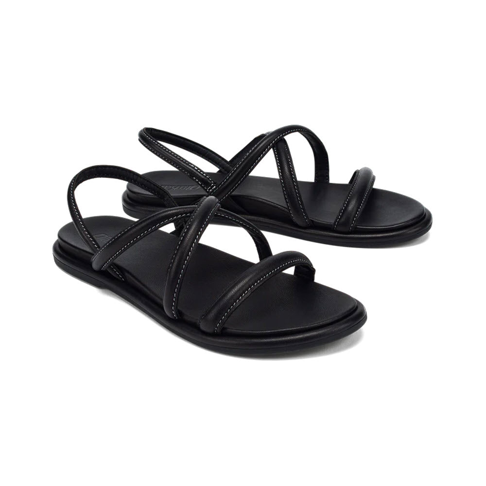 A pair of black Olukai Tiare Strappy sandals with flat soles, displayed against a white background.