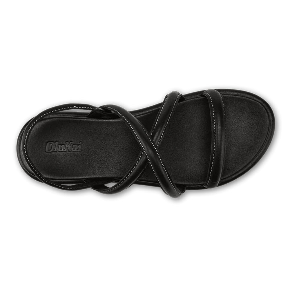 A pair of black leather Olukai Tiare Strappy sandals on a white background, viewed from above.