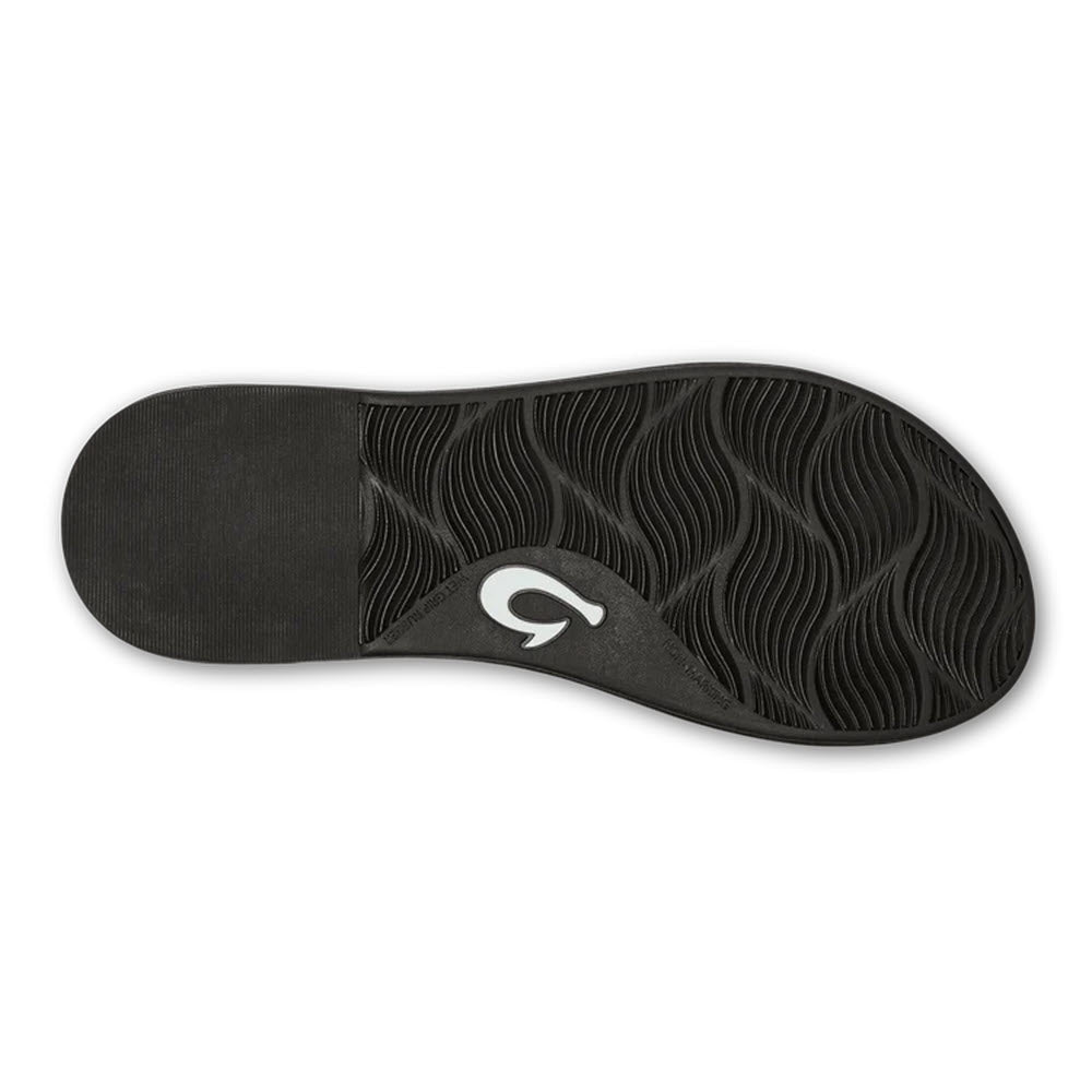 Black leather Olukai Tiare Strappy sandal sole with a wavy pattern and a circular logo in the center.