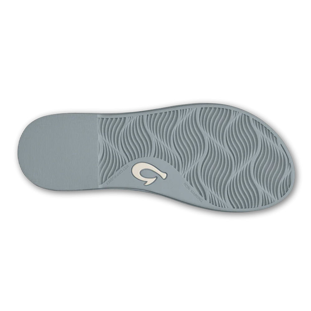 Bottom view of a light gray leather sandal sole with a wavy tread pattern and a circular logo in the center of the Olukai Tiare Strappy Silver - Womens.