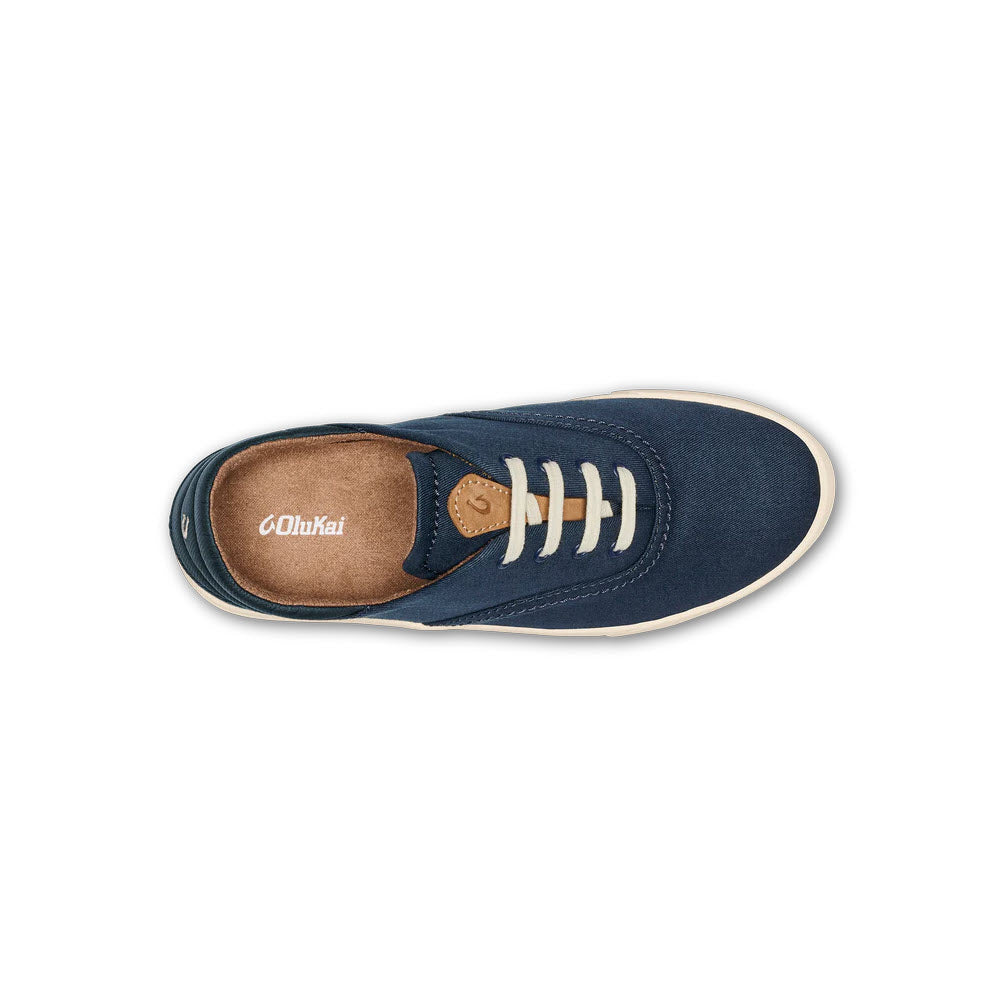Top view of a single Olukai Kohu Navy - Womens sneaker with white laces and a tan interior, isolated on a white background.