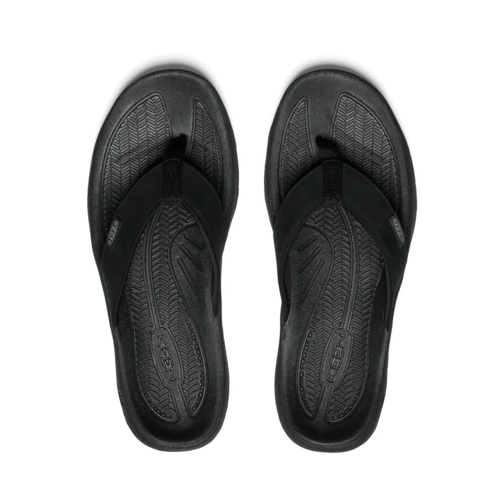 A pair of Keen Kona Flip TG Black Steel Grey flip-flops with textured, arch support soles, positioned symmetrically from a top-down view.
