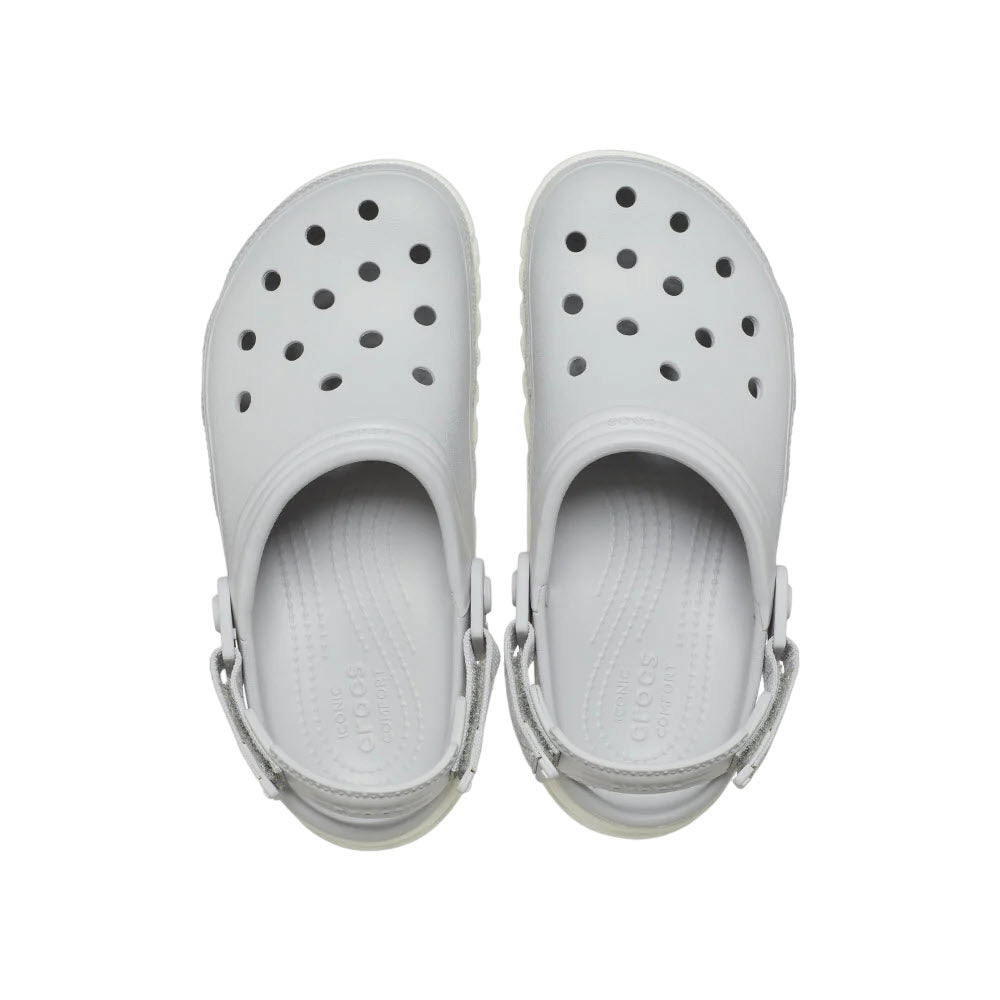A pair of white Crocs Duet Max II clogs viewed from above, showcasing their top and inner sole with ventilation holes.