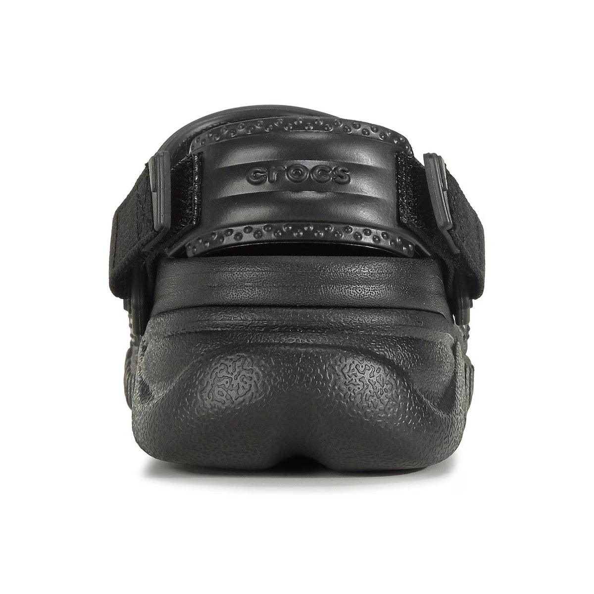 A black Crocs leather fanny pack with embossed patterns and studded detail, featuring adjustable back straps, viewed from the front.