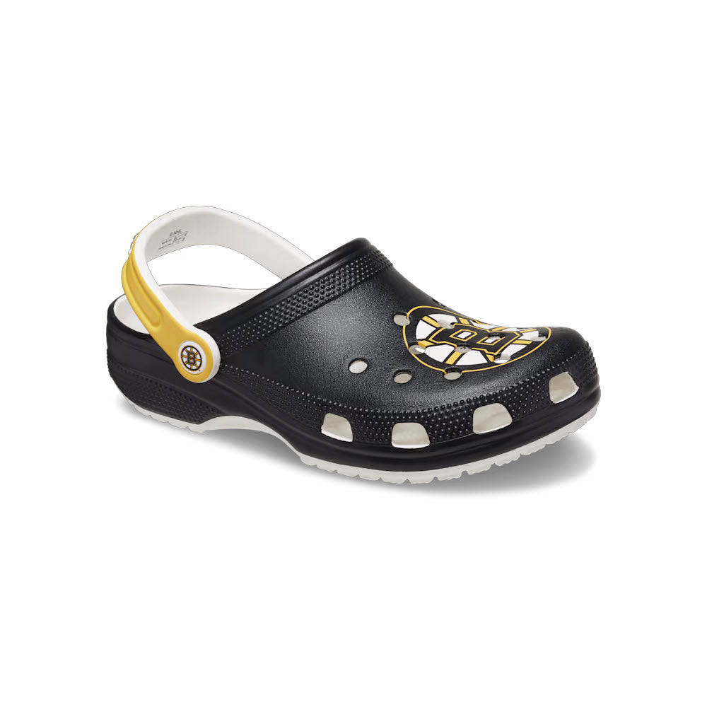 A black and yellow Crocs Boston Bruins Classic Clog White - Mens with an open heel, perforated upper, and a decorative emblem on the side.