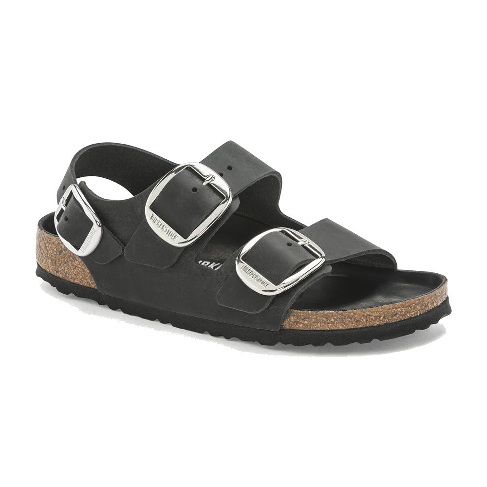 Black double-strap Birkenstock Milano sandal with Big Buckle on a white background, featuring a cork footbed and a flat sole.