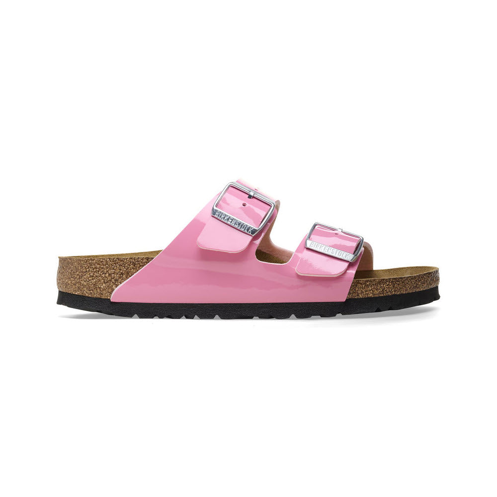 A pair of pink Birkenstock Arizona sandals with adjustable straps and a cork footbed, isolated on a white background.