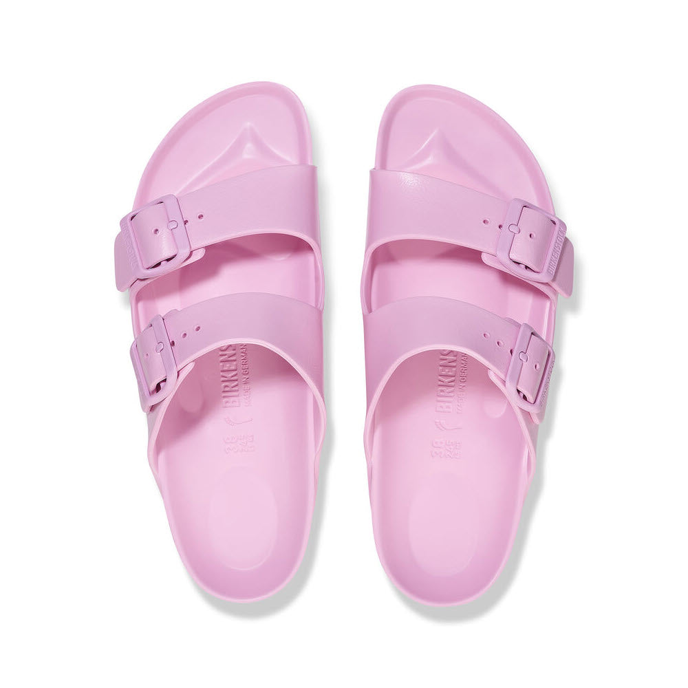 A pair of pink Birkenstock Arizona EVA Fondant Pink sandals with adjustable straps, viewed from above on a white background.