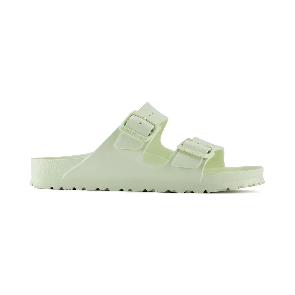 A single pale green Birkenstock Arizona sandal with two adjustable straps and a chunky sole, displayed on a white background.