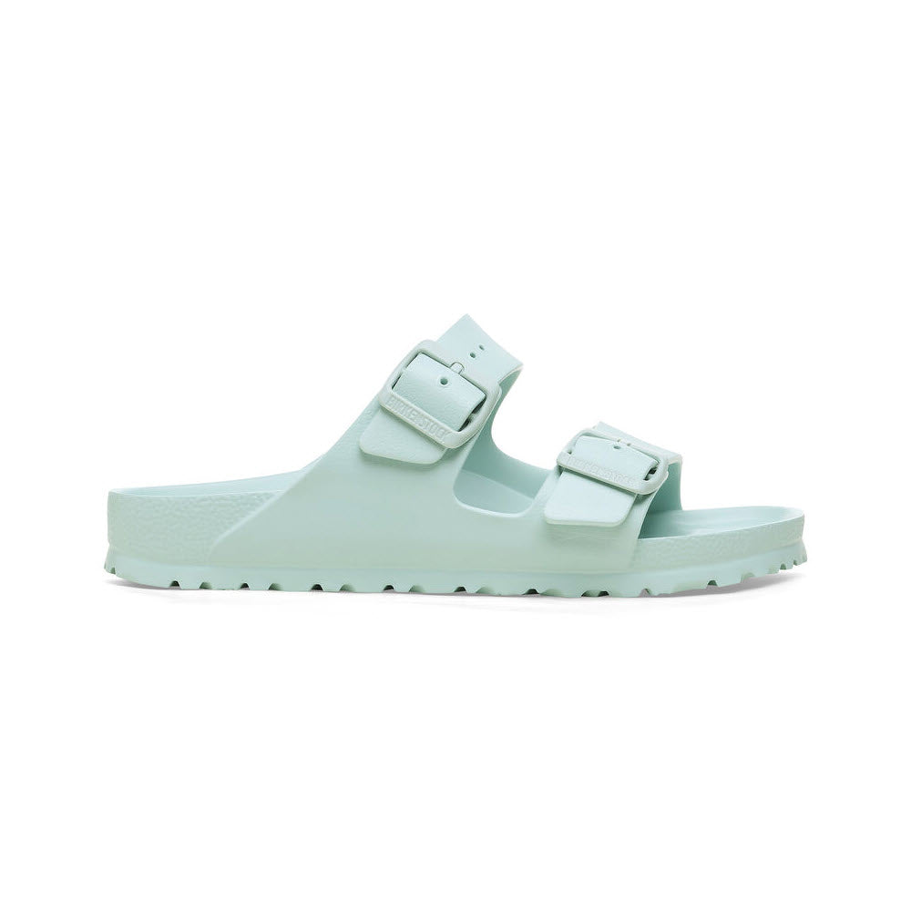 A light green Birkenstock Arizona EVA Surf Green sandal with two adjustable straps and a flat sole, isolated on a white background.