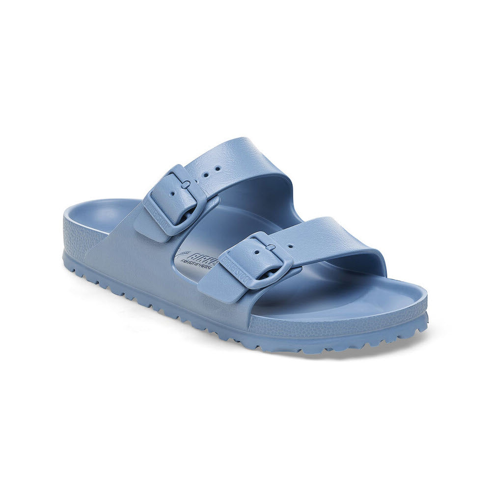 A pair of light blue Birkenstock Arizona EVA Elemental Blue sandals with adjustable straps and a flat sole, isolated on a white background.