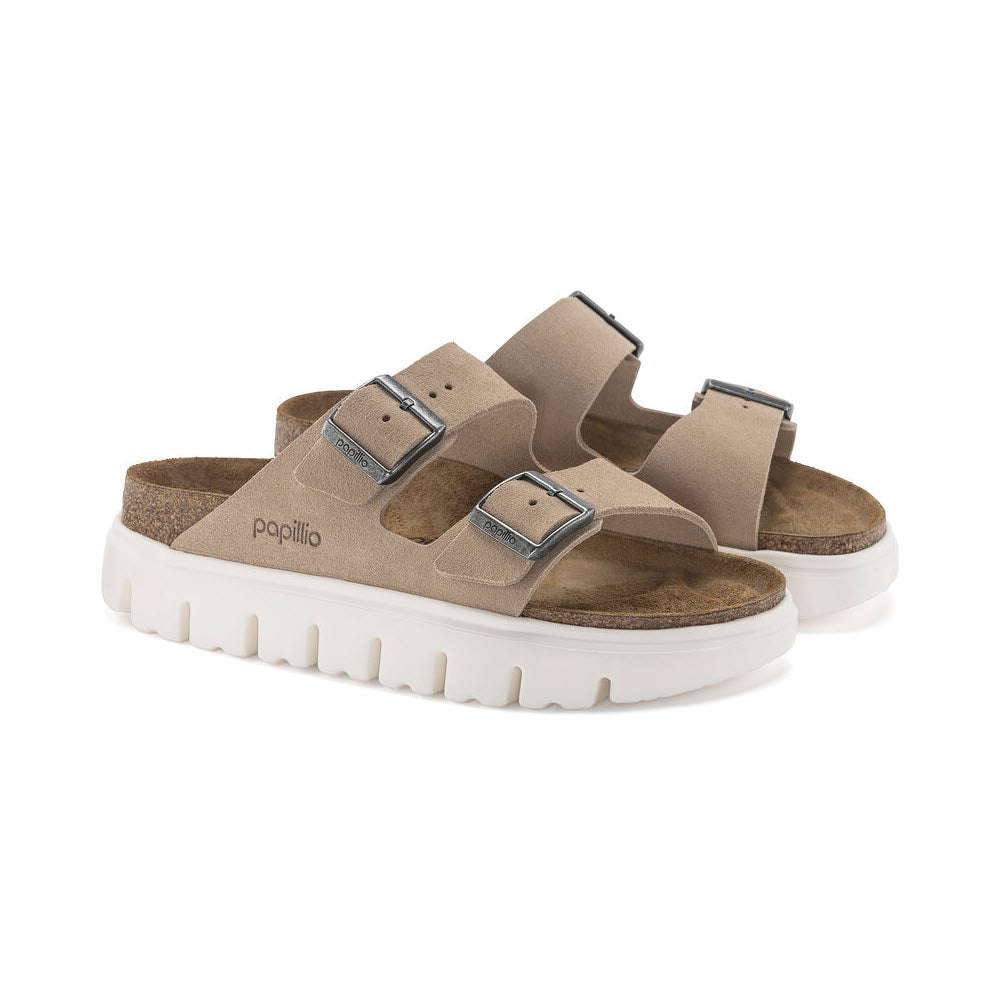 A pair of beige Birkenstock Arizona Chunky Warm Sand sandals with adjustable straps and contoured footbed on a white background.