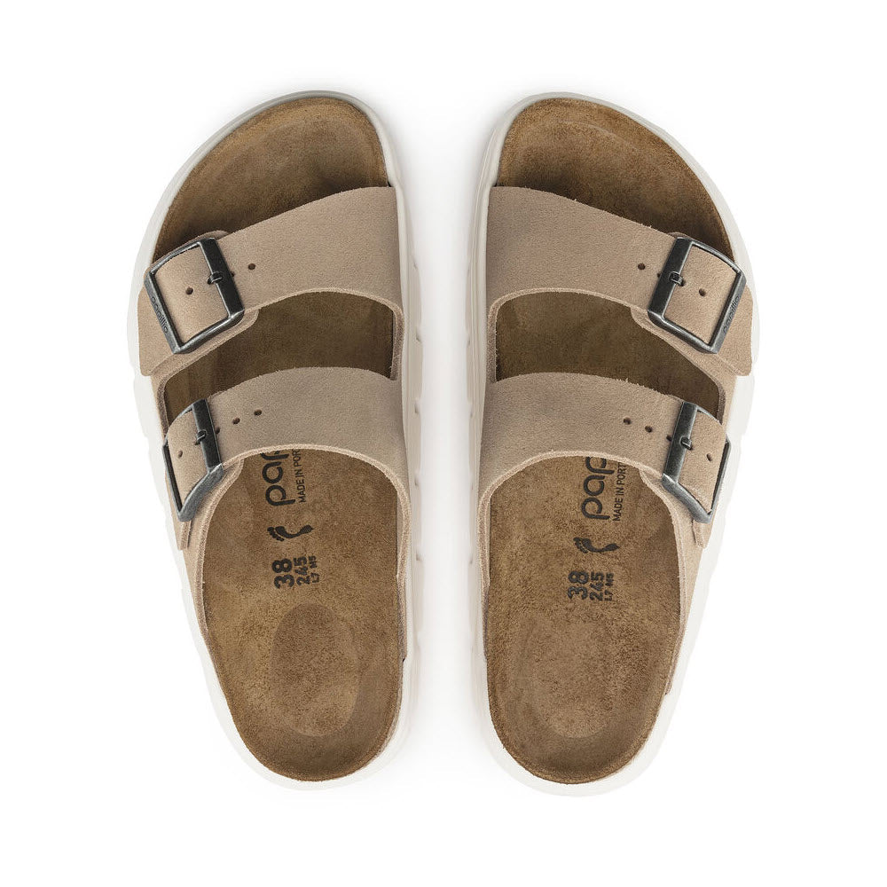 A pair of beige suede Birkenstock Arizona Chunky Warm Sand sandals with three adjustable straps and a contoured footbed, displayed from above on a white background.