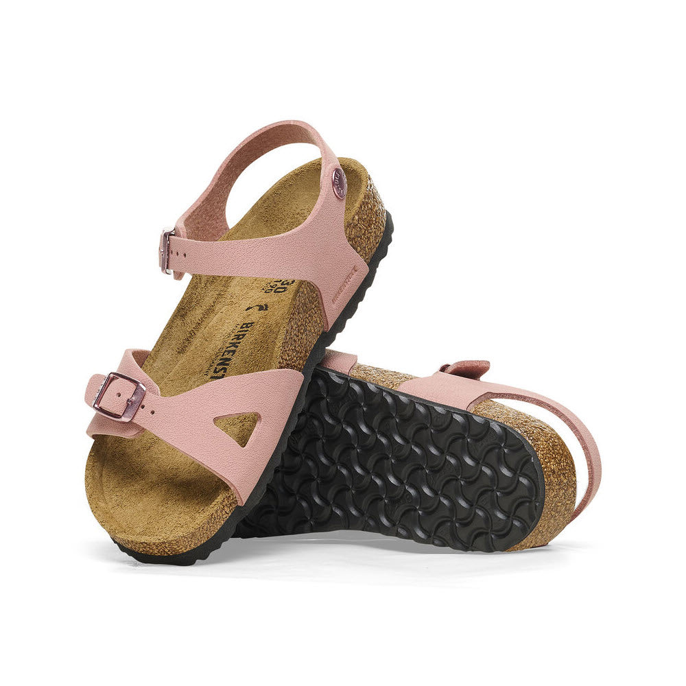 A pair of pink BIRKENSTOCK RIO PINK CLAY BIRKIBUC - KIDS sandals with contoured footbeds and adjustable straps, displayed against a white background.