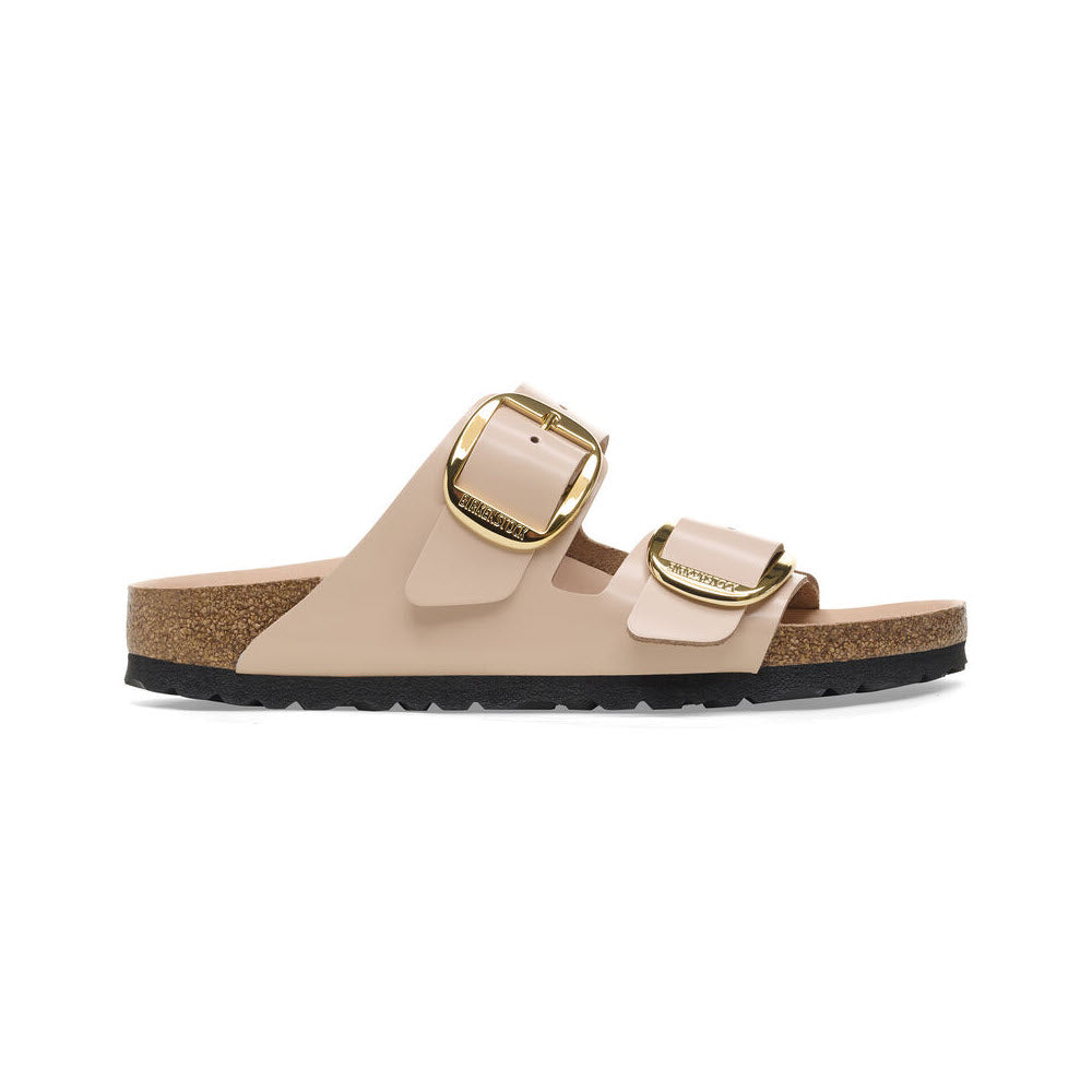 A pair of natural leather Birkenstock Arizona Big Buckle High Shine New Beige sandals with large golden buckles and a cork sole, isolated on a white background.