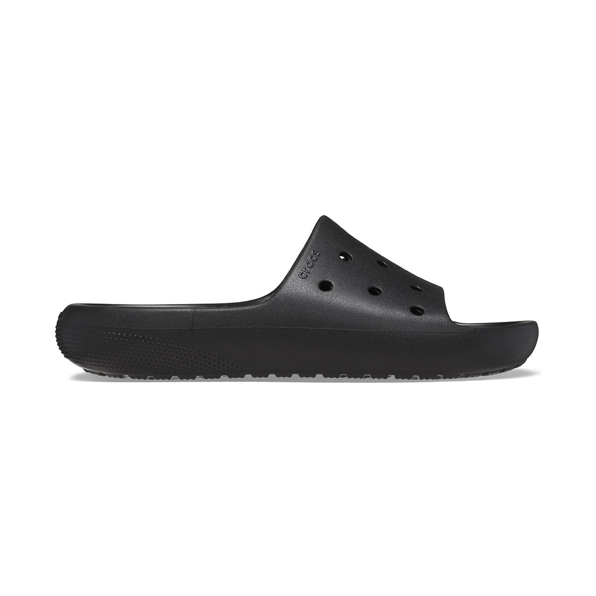 Side view of a black CROCS CLASSIC CROC SLIDE V2 SANDAL from the Crocs Collection with ventilation holes on the top and a textured sole.