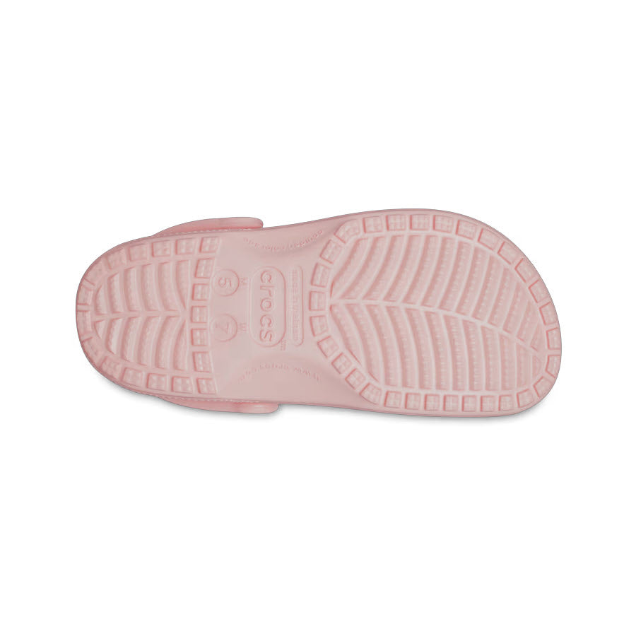 Sole of a pink Crocs Classic Clog Quartz - Womens showing treads and Crocs brand name imprinted.