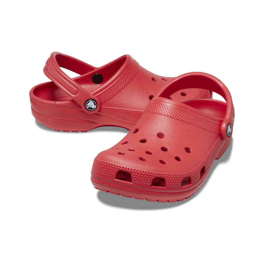 A pair of red iconic Crocs Classic Clog Varsity Red shoes on a white background.