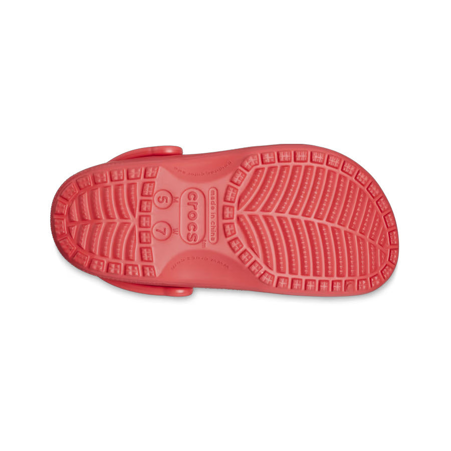 Crocs Classic Clog Varsity Red sole displayed against a white background, highlighting the textured tread pattern and branded details.