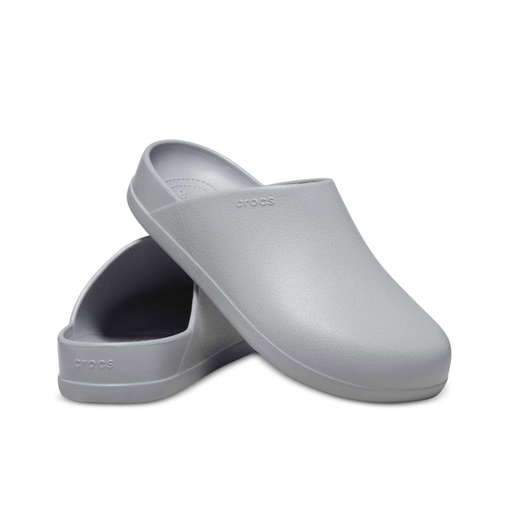 A pair of gray Crocs Dylan Clog Light Grey slip-on shoes against a white background.