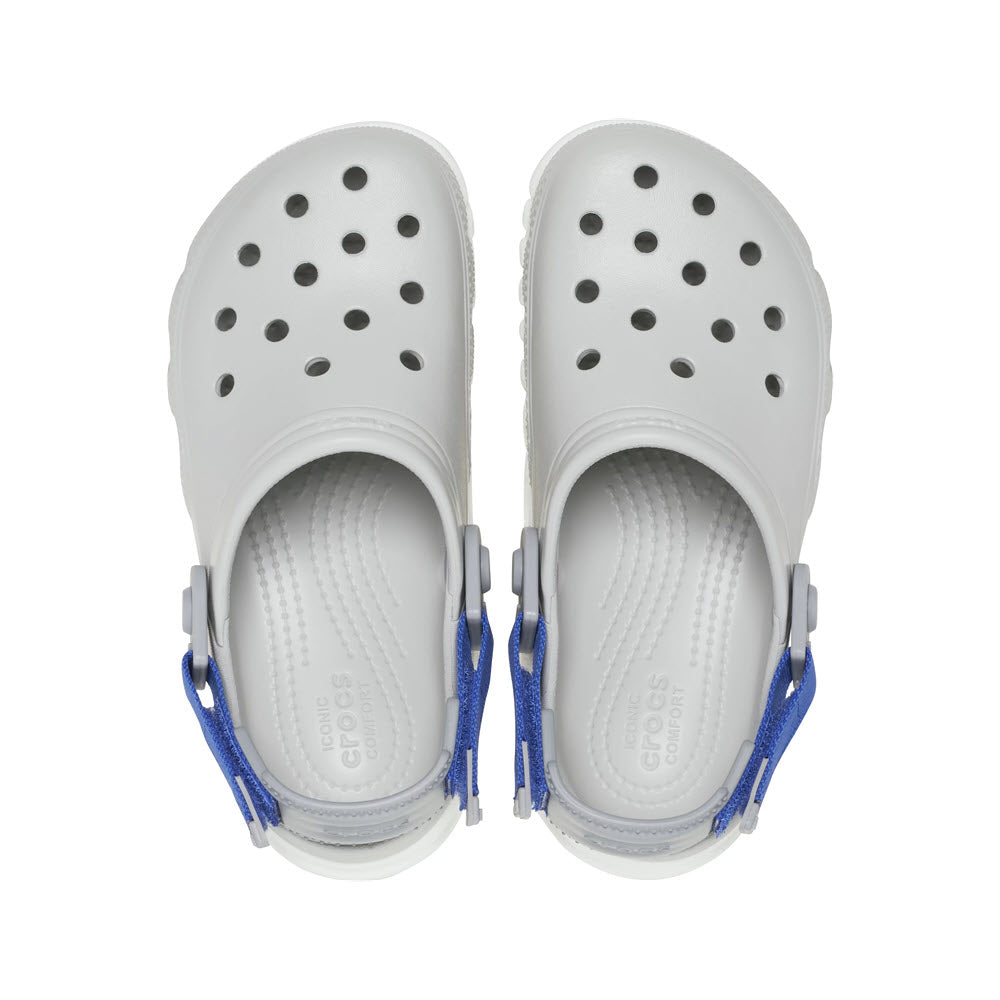 A pair of white Crocs Duet Max Clog Atmosphere sandals with blue straps viewed from above, embodying a sport-inspired street style.