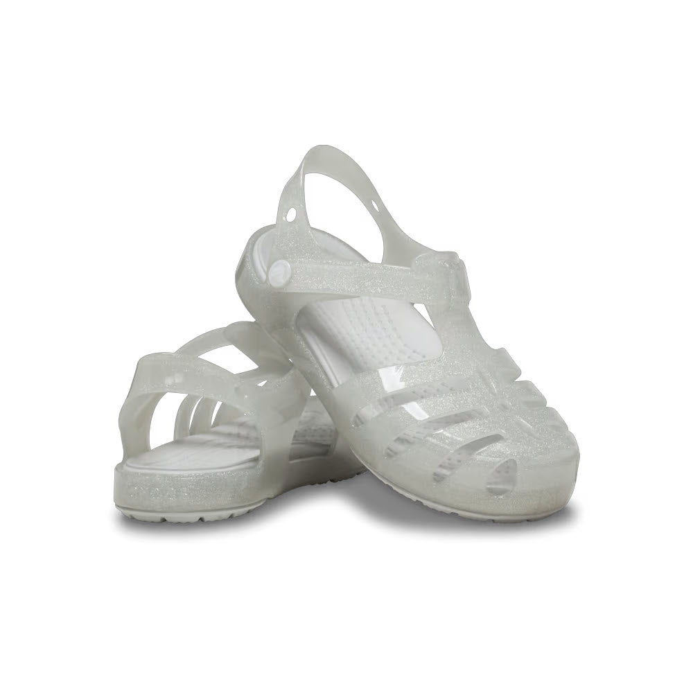A pair of white kids&#39; Crocs Isabella Glitter Silver sandals with jelly straps on a white background.
