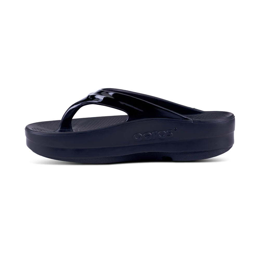 OOFOS OOMEGA OOLALA black flip-flop sandal on a white background.