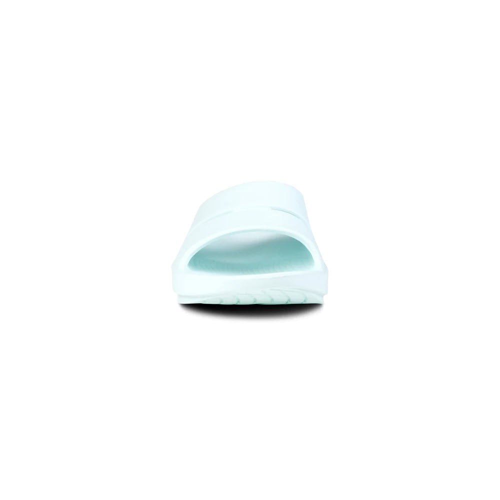 A single light blue slide sandal featuring OOfoam technology displayed against a white background, viewed from the front, the OOFOS OOFOS OOAHH ICE - WOMENS by Oofos.
