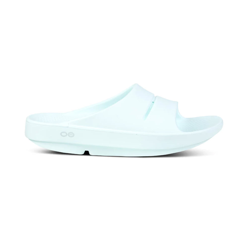 A single light blue Oofos Oofos Ooahh Ice - Womens athletic shoe slide sandal with a thick sole, isolated on a white background.