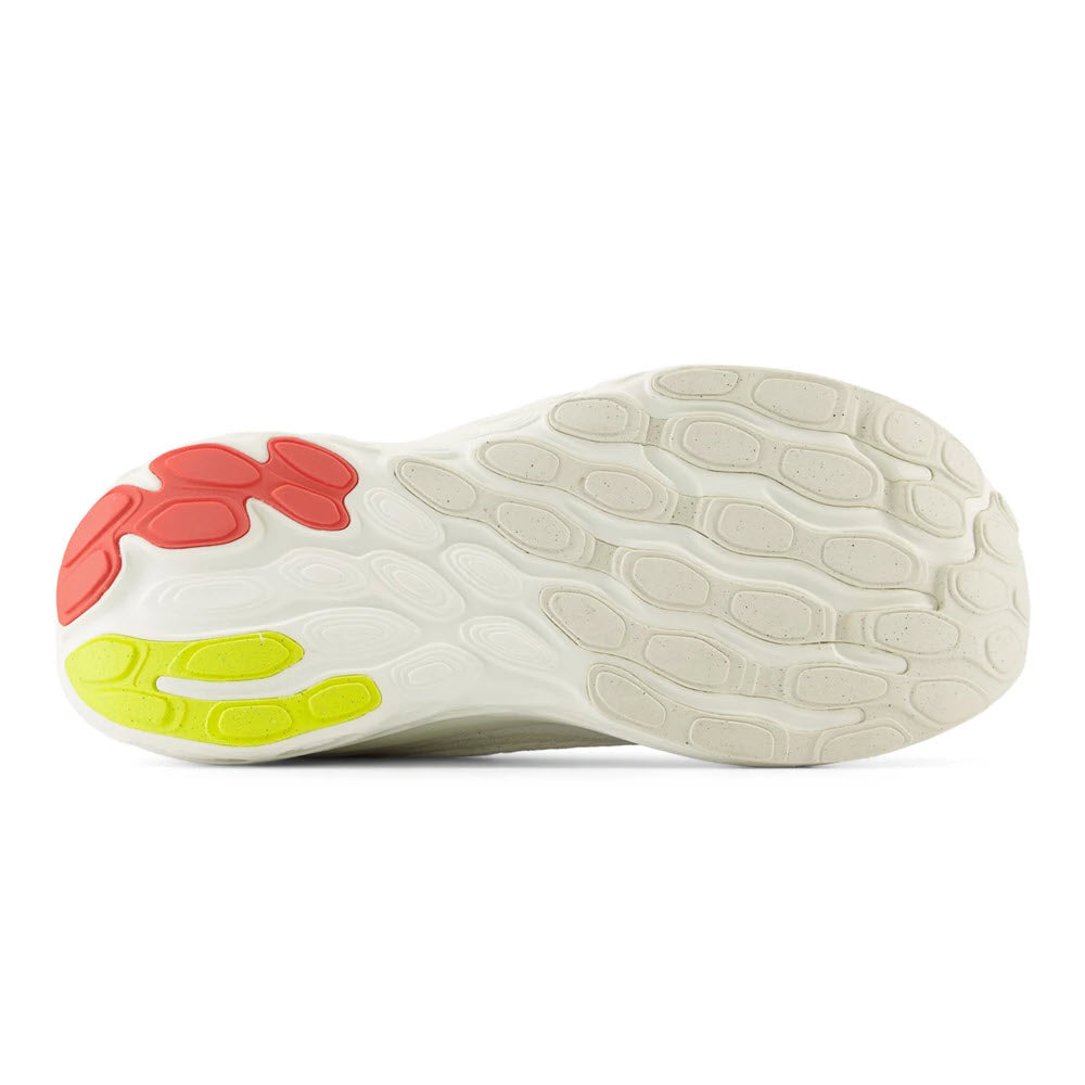 A high-performance New Balance 1080v13 running shoe sole with red and yellow traction pads on a white background.