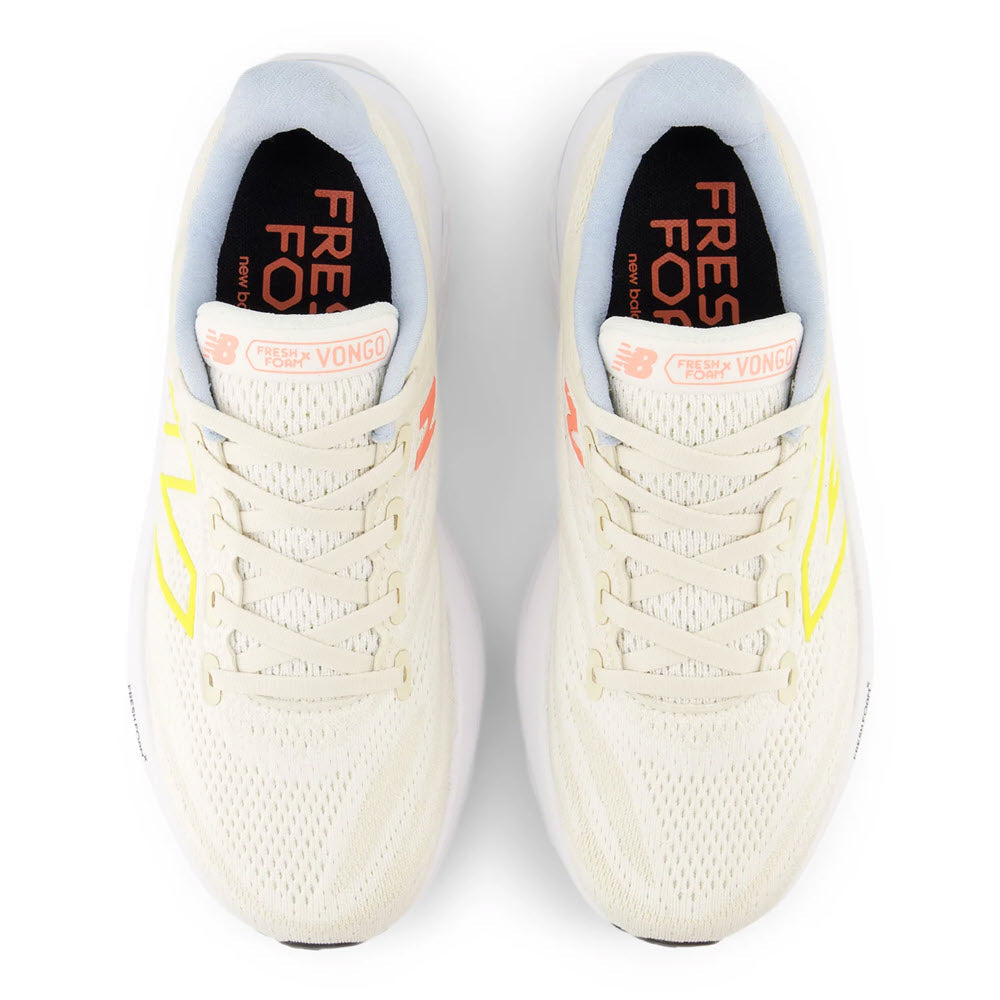 Top view of a pair of New Balance Vongo V6 running shoes in sea salt, lemon zest, and light chrome with yellow and orange accents, designed for a cushioned ride.