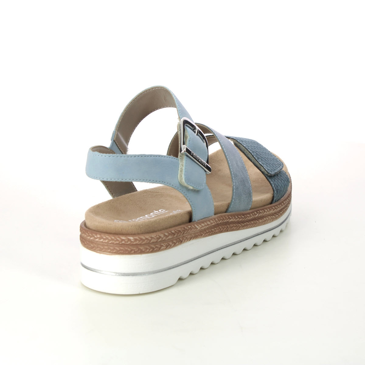 A Remonte women&#39;s sandal featuring blue straps, a buckle, and a chunky white platform sole with shock-absorbing properties, displayed against a plain white background.