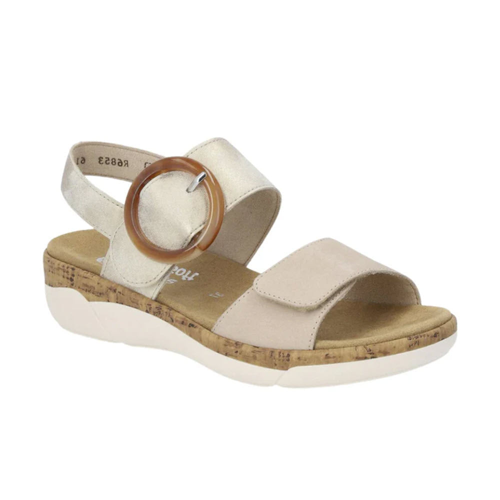 Remonte light metallic women&#39;s strap sandals with a cork wedge sole and a large circular buckle on the hook and loop fastener strap.