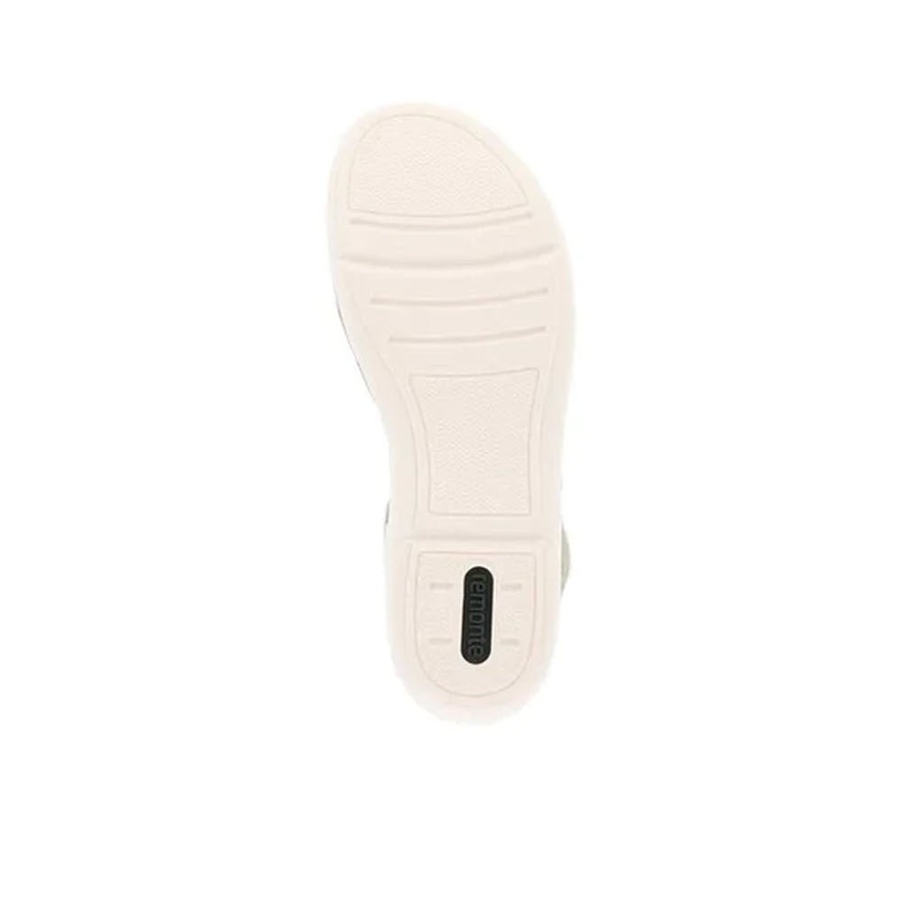 The underside of a Remonte three strap adjustable sandal white - womens featuring a textured sole and a small, rectangular black label in the center.
