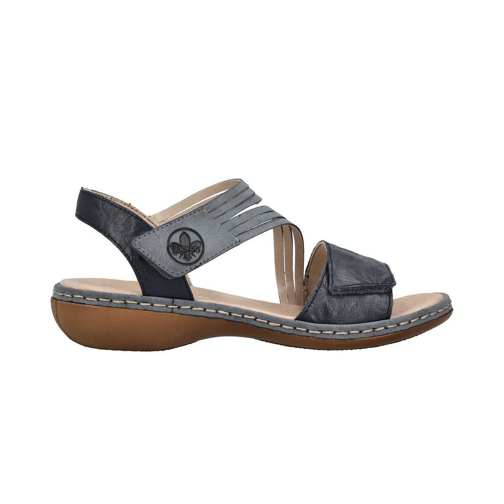 A single RIEKER COMFORT BOTTOM ASYMMETRICAL SANDAL BLUE - WOMENS with an adjustable hook and loop fastener and a flat sole, displayed against a white background.