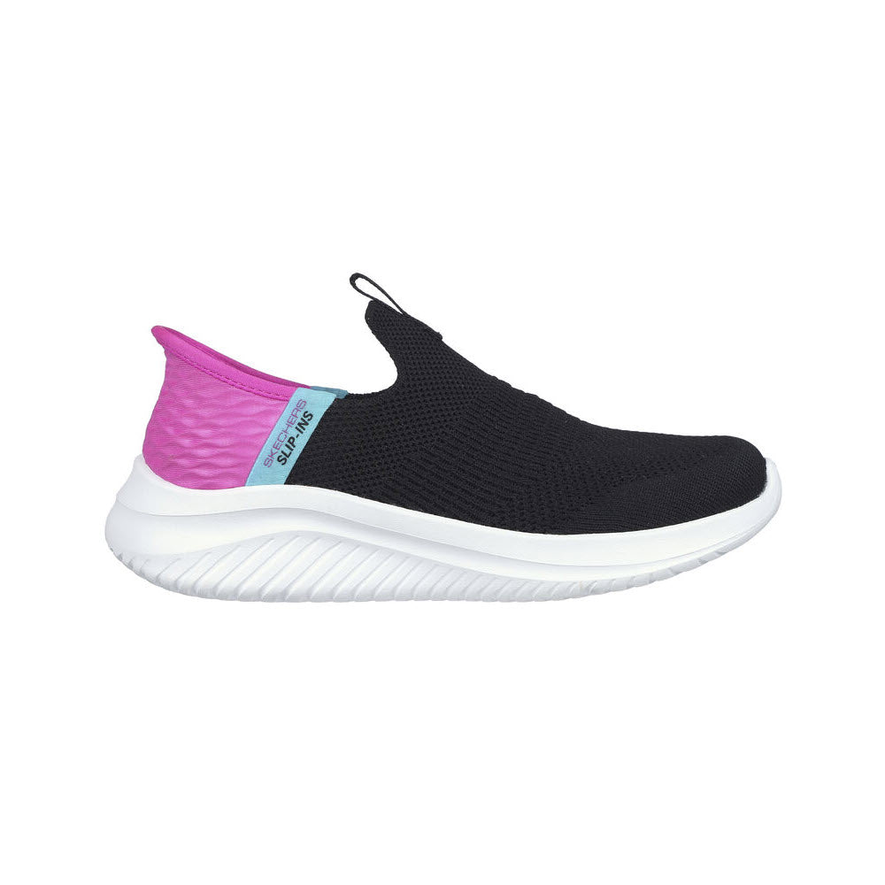 A black slip-on athletic shoe with a white sole, bright pink heel, and a blue label on the side. The shoe features a textured knit upper and a pull tab at the top.