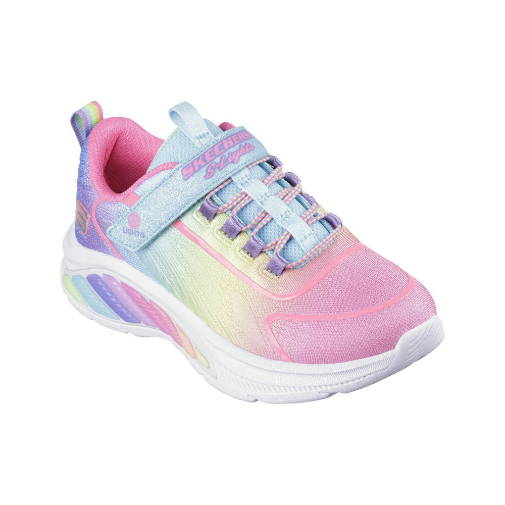A colorful children&#39;s sneaker featuring an ombre woven upper in pastel pink, yellow, and blue shades, with Skechers branding and lighted soles.