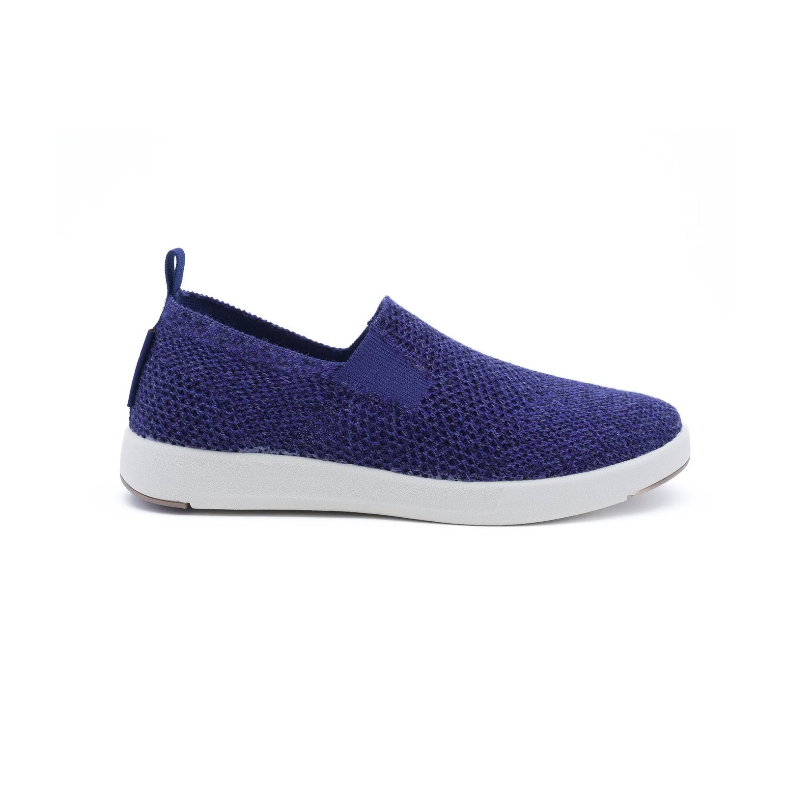 Introducing the Woolloomooloo Suffolk Navy for women: a slip-on shoe with a white sole, showcasing a knitted Merino wool texture in navy blue. It features a convenient pull tab at the heel for easy wear. Designed for orthopedic comfort, these washable sneakers combine style and practicality.